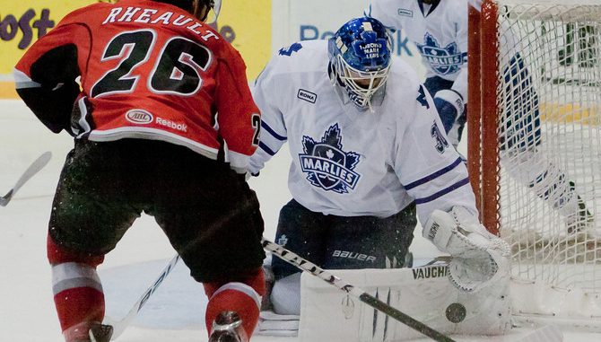 Toronto Marlies goalie Ben Scrivens makes a big save on Abbotsford Heat forward Jon Rheault in game two of the Western Conference Semifinal in the AHL playoffs. Toronto won the game 5-1 at Ricoh Coliseum to even the series at 1-1 (JP Dhanoa)